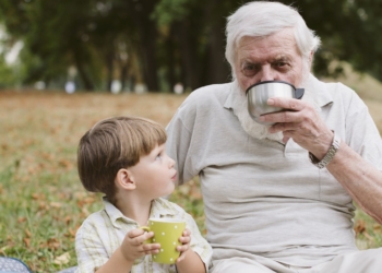 Grandpa grandson park drinking tea