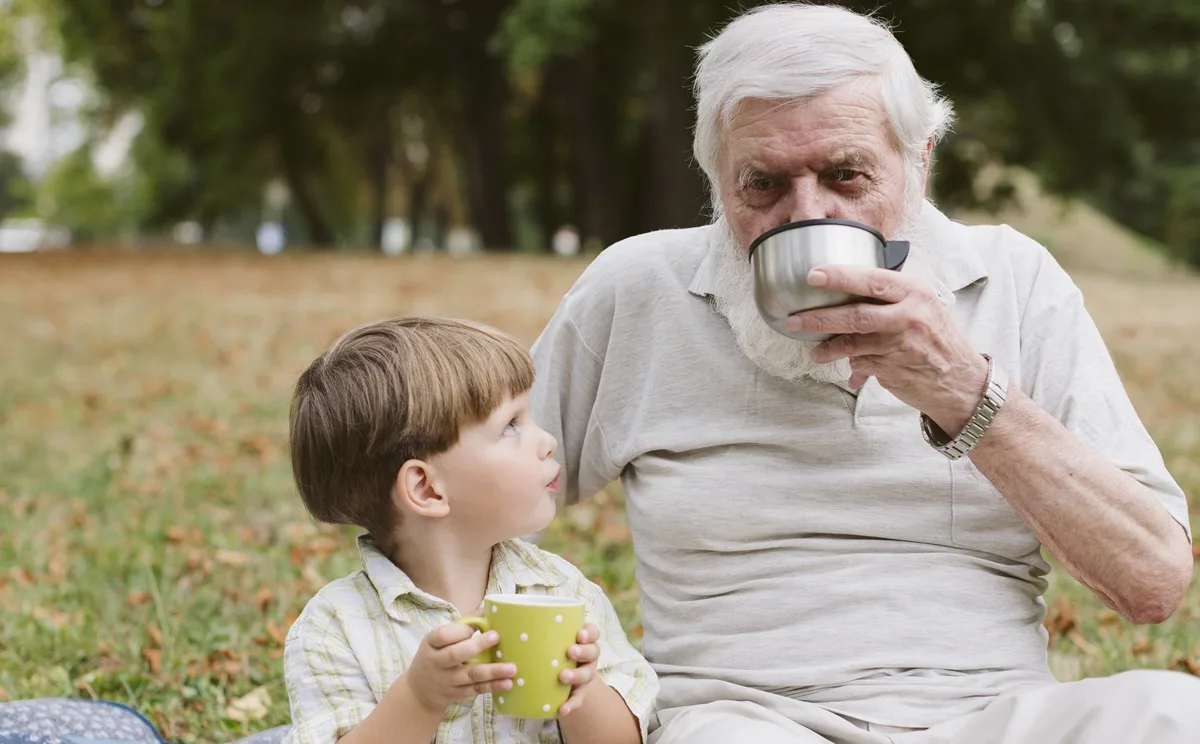 grandpa grandson park drinking tea