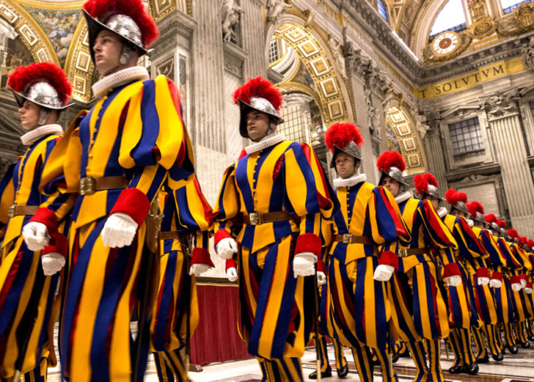 VATICAN CITY, VATICAN - OCTOBER 04: Swiss Guards attend a mass on the occasion of the New Pontifical Swiss Guards swearing in ceremony in St. Peter's Basilica on October 04, 2020 in Vatican City, Vatican. The annual swearing in ceremony for the New Papal Swiss Guards usually takes place every year on May 6, commemorating the 147 soldiers who died defending Pope Clement VII on the same day in 1527 during the sack of Rome.  38 new recruits will join the military unit whose responsibility is to protect the Pope. For the first time this year, due to the COVID-19 pandemic the solemn ceremony was postponed to October.  (Photo by Alessandra Benedetti - Corbis/Corbis via Getty Images)