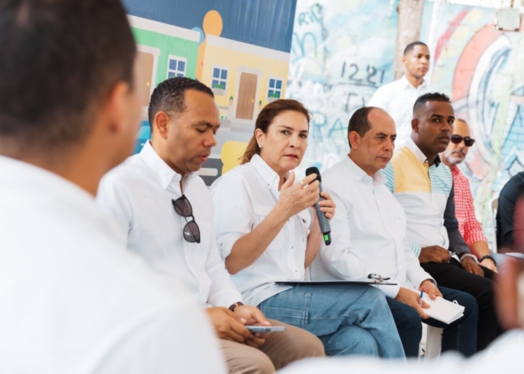 Alcaldesa Carolina Mejía conversando con residentes de Los Praditos durante el programa 'La Alcaldía Llega a Ti', con un ambiente comunitario.