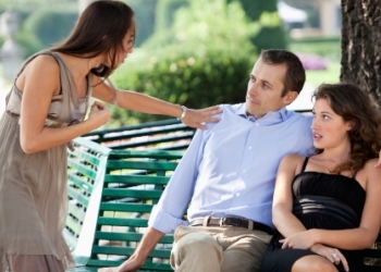 Woman confronting her boyfriend after being caught with other woman