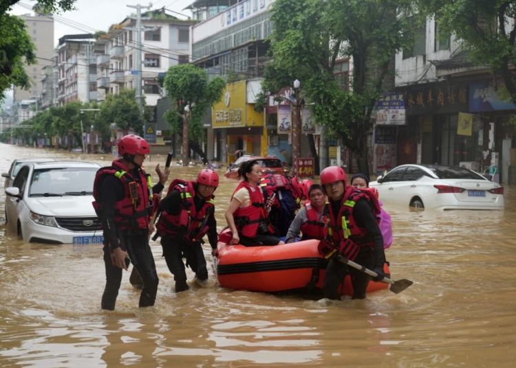 Rescuers help evacuate residents from a flooded street in Rongjiang, in Chinas southwest Guizhou province on June 24, 2025. Severe flooding in China's southwestern province of Guizhou has forced more than 80,000 people to flee their homes, Beijing's state media said on June 25. (Photo by AFP) / China OUT / CHINA OUT / CHINA OUT