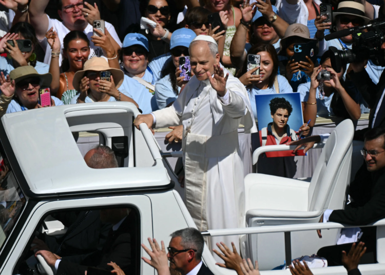 Pope Leo XIV greets faithful as he leaves in the Pope Mobile after presiding a Holy Mass and canonisation of Blessed Carlo Acutis and Pier Giorgio Frassati in St Peter's Square at the Vatican on September 7, 2025. An Italian teenager dubbed "God's Influencer" for his efforts to spread the Catholic faith online will become the first millennial saint Sunday at a canonisation attended by thousands of pilgrims. Computer whiz Carlo Acutis, who died of leukemia in 2006 aged 15, will be raised to sainthood by Pope Leo XIV in a solemn ceremony in St Peter's Square at the Vatican. Italian Pier Giorgio Frassati, a mountaineering enthusiast who died in 1925 and was known for his social and spiritual commitment, will also be made a saint on September 7, 2025. (Photo by Filippo MONTEFORTE / AFP)