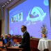 Nobel Committee Secretary General Thomas Perlmann (foreground) addresses journalists in front of a screen displaying the portraits of (L-R) Mary E Brunkow, Fred Ramsdell and Shimon Sakaguchi during a press conference where the winners of the 2025 Nobel Prize in Physiology or Medicine are being announced at the Karolinska Institute in Stockholm, Sweden, on October 6, 2025. Mary E. Brunkow and Fred Ramsdell of the United States and Japan's Shimon Sakaguchi won the Nobel Prize in Medicine on Monday for research into how the immune system is kept in check, the Nobel jury said. (Photo by Jonathan Nackstrand / AFP)