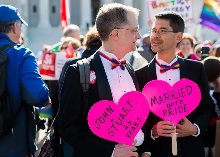 Married couple john lewis, left, and stuart gaffney, of san francisco, hold heart signs outside the u. S. Supreme court before the start of oral arguments on marriage equality on tuesday, april 28, 2015. Lewis and gaffney were plaintiffs in the 2008 court case