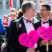 Married couple John Lewis, left, and Stuart Gaffney, of San Francisco, hold heart signs outside the U.S. Supreme Court before the start of oral arguments on marriage equality on Tuesday, April 28, 2015. Lewis and Gaffney were plaintiffs in the 2008 court case