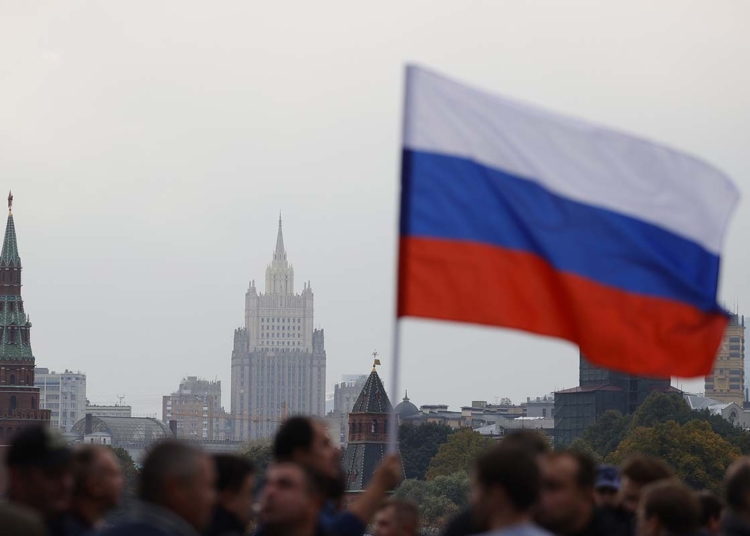 MOSCOW, RUSSIA - SEPTEMBER 30: People holding Russian flags gather at Red Square during a ceremony marking the annexation of four regions of Ukraine after referendums on September 30, 2022, in Moscow, Russia. The referendums took place in Donetsk, Kherson, Luhansk, Zaporizhzhia regions have been condemned by the international community, with European nations and the US calling them "sham" and that they will not be recognized. (Photo by Sefa Karacan/Anadolu Agency via Getty Images)
