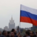 MOSCOW, RUSSIA - SEPTEMBER 30: People holding Russian flags gather at Red Square during a ceremony marking the annexation of four regions of Ukraine after referendums on September 30, 2022, in Moscow, Russia. The referendums took place in Donetsk, Kherson, Luhansk, Zaporizhzhia regions have been condemned by the international community, with European nations and the US calling them "sham" and that they will not be recognized. (Photo by Sefa Karacan/Anadolu Agency via Getty Images)