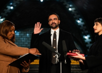 New york mayor-elect zohran mamdani (c) places his hand on a quran as he is sworn in by new york attorney general letitia james (l) and his wife rama duwaji looks on in new york, on january 1, 2026. New york mayor-elect zohran mamdani is set to become the us city's first muslim mayor, and the youthful optimism of his democratic socialist platform will be put to the test as he takes office on january 1, 2026, with high expectations. (photo by amir hamja / pool / afp)