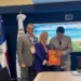 David Collado entrega libro “Santo Domingo” a CEO de PAX Assistance en Anato