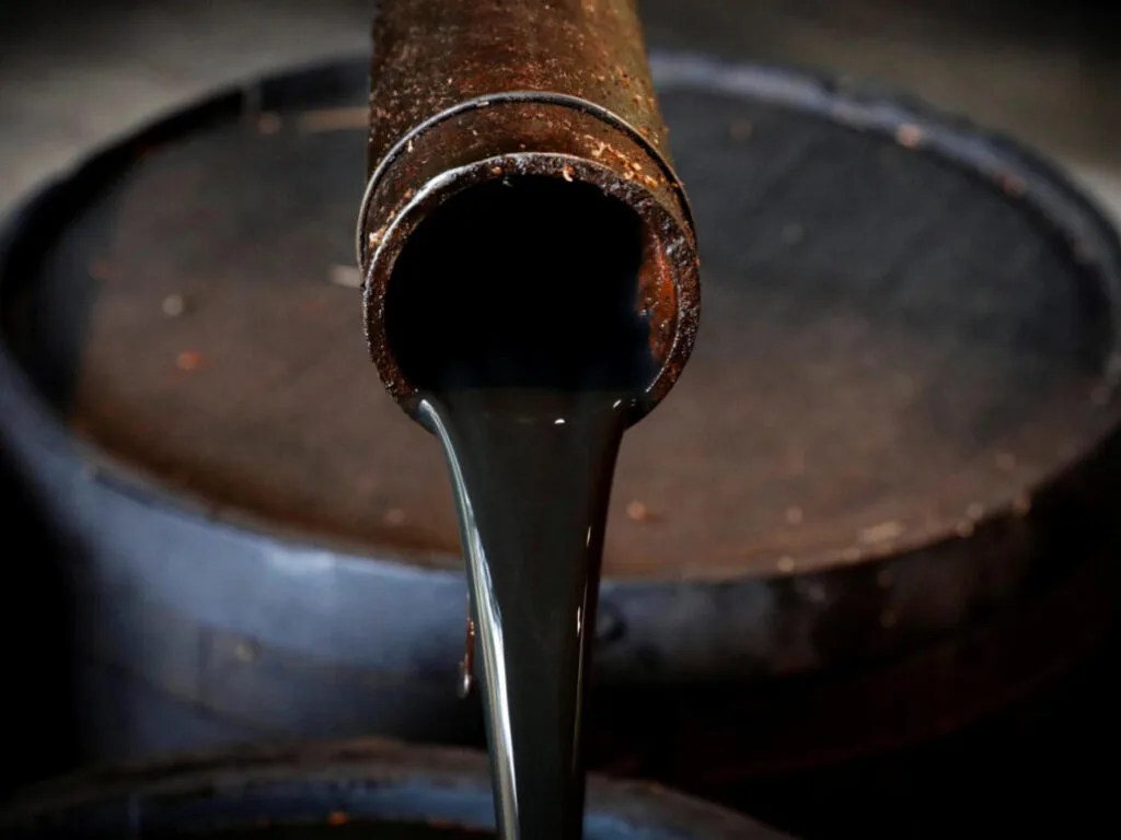 FILE PHOTO: Oil pours out of a spout from Edwin Drake's original 1859 well that launched the modern petroleum industry at the Drake Well Museum and Park in Titusville, Pennsylvania U.S., October 5, 2017. REUTERS/Brendan McDermid/File Photo